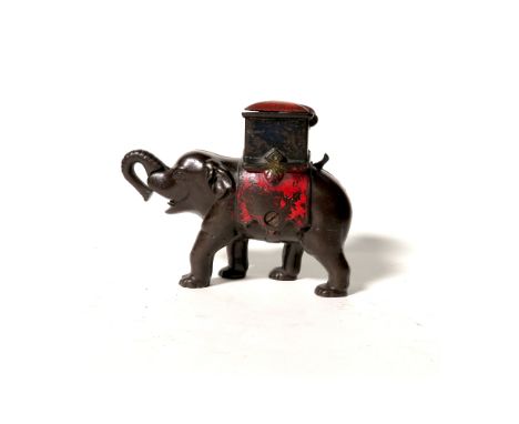 An original late 19th century novelty cast iron money bank modelled as an Indian elephant with figure rising from the howdah 