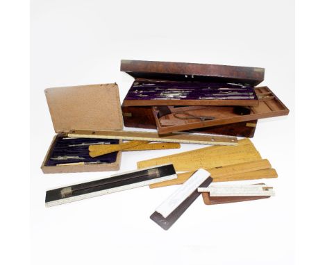 A walnut-cased geometry set with purple velvet interior, some pieces with ivory handles, two marked 'Army &amp; Navy C.S.L', 