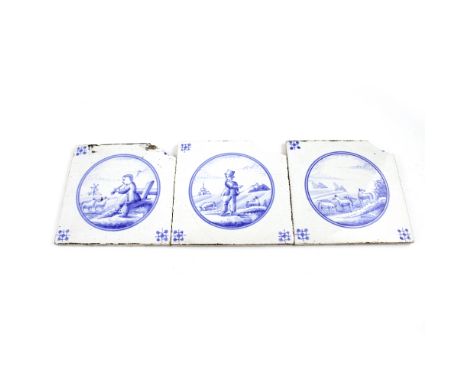 A pair of 18th century Dutch Delft blue and white ceramic tiles depicting scenes of shepherds and sheep and one other, each 1