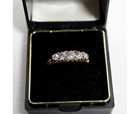 An 18ct gold claw set five stone diamond ring, size N, approx 2.9g.