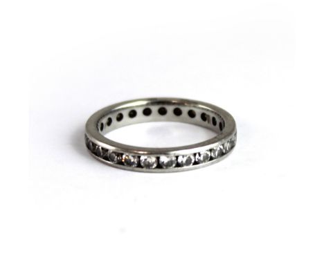 A platinum and chip diamond eternity ring, size J, approx 2.5g.