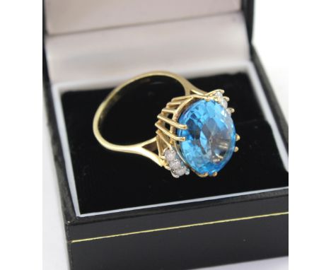 A 9ct gold chip diamond and large blue topaz dress ring, central stone approx 1.5cm, size P 1/2, approx 10g.