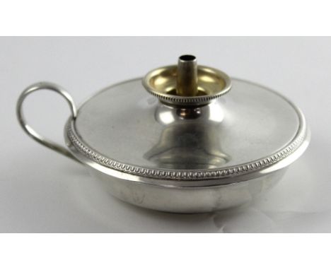 An early 20th century hallmarked silver table lighter with loop handle, diameter approx 9cm, assayed London, marks rubbed, ap
