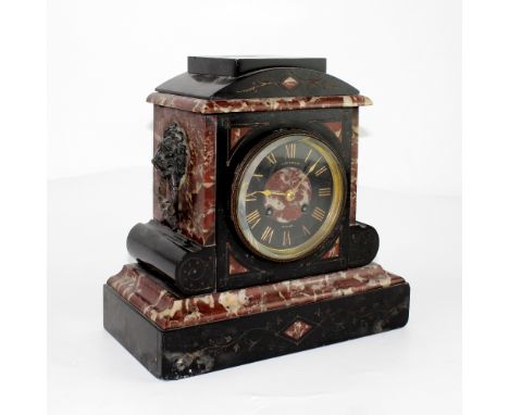 A black slate and red marble mantel clock, the dial set with Roman numerals and marked 'Bright &amp; Co Buxton' with twin-tra