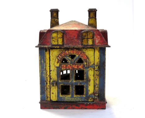 An original late 19th century novelty cast iron money bank inscribed, 'Novelty Bank', with figure hinged to the front door, s
