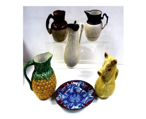Five ceramic jugs to include one in the form of a pig, one in the form of a pineapple and a Staffordshire plate decorated wit