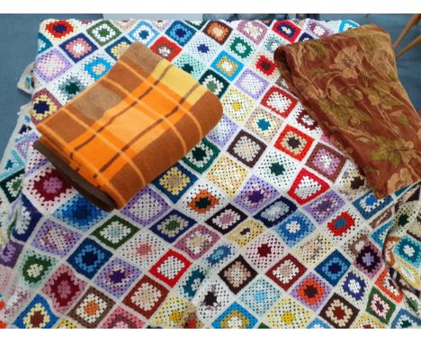 A 1970's knitted and crotchet woollen patchwork throw, 3m x 2.5m, having a white border A/F, together with a Retro orange tar