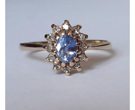 A 9ct gold and pale blue stone with 12 diamond surround dress ring, makers initials DOM, total weight 1.8g, UK ring size N. L