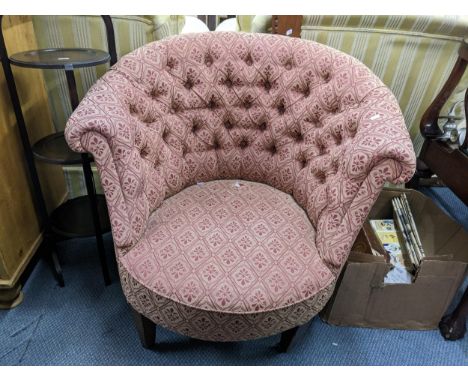 An early 20th century button back upholstered tub chair on tapering legs and castors Location: 