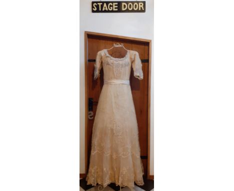 Circa early 1900's, a Marshall & Snelgrove of Oxford Street, cream embroidered wedding dress having an applique embroidered a