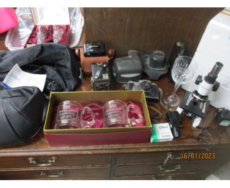 A mixed lot to include vintage cameras, including a Zenit B, and a Polaroid, a Sci-Mart electric microscope with slides, and 