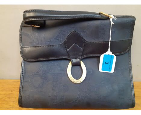 Christian Dior - A vintage navy handbag having iconic branding throughout to the exterior with navy leather piping, handles a