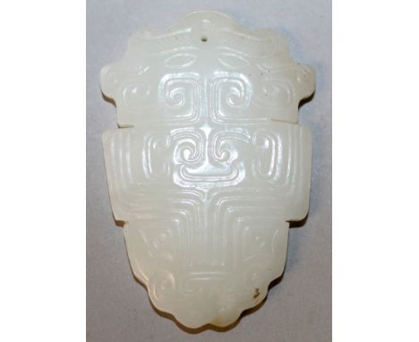 A CHINESE WHITE JADE-LIKE PENDANT, of archaic design, 2.2in high.