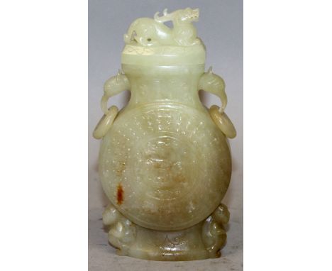 A CHINESE CELADON JADE VASE & COVER, of archaic form and with loose ring handles, 5.25in high.