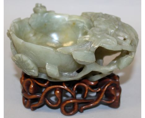 A GOOD 19TH CENTURY CHINESE CELADON JADE BRUSHWASHER, together with a carved and pierced fitted hardwood stand, the sides of 