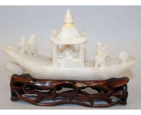 AN EARLY 20TH CENTURY CHINESE JADE MODEL OF A RIVER BOAT, together with a fitted wood stand, the stone of grey-white hue, the