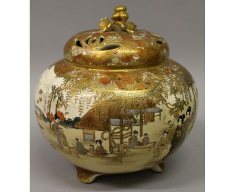 AN EARLY 20TH CENTURY JAPANESE SATSUMA EARTHENWARE TRIPOD KORO & COVER, the sides of the lobed body painted with a continuous