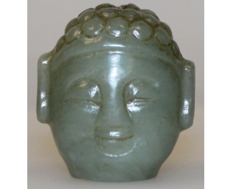 A 19TH/20TH CENTURY CHINESE CELADON GREEN JADE BEAD, carved in the form of Buddha's head, 1.25in high.