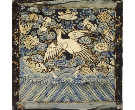 AN EARLY 20TH CENTURY CHINESE 5TH GRADE EMBROIDERED SILK RANK BADGE, mounted on a wood panel, the badge decorated with a silv