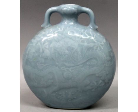 A GOOD QUALITY CHINESE CLAIRE-DE-LUNE PORCELAIN MOON FLASK, each side moulded beneath the glaze with a sinuous dragon amidst 