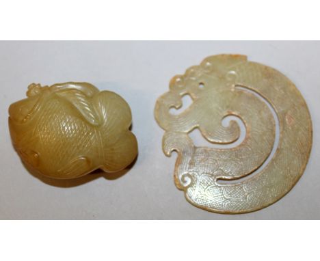 A CHINESE JADE-LIKE PENDANT IN THE FORM OF A COILED DRAGON, and of archaic design, 2.1in diameter; together with a soapstone-