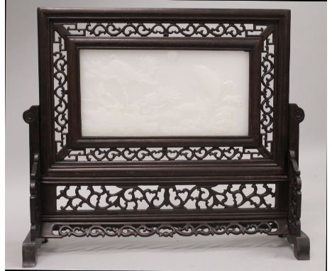 A CHINESE HARDWOOD & WHITE JADE-LIKE TABLE SCREEN, the inset panel decorated in relief with a carp jumping from waves and wit