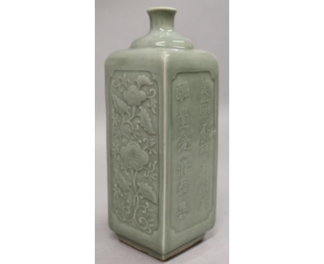 A CHINESE SQUARE SECTION CELADON PORCELAIN FLASK, the sides moulded beneath the glaze with calligraphy and with formal scroll