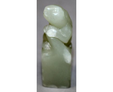 A SMALL 20TH CENTURY CHINESE CELADON JADE SEAL, of square-section, unusually surmounted by a hare, 1.9in high.