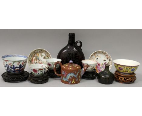 A GROUP OF NINE ITEMS OF ORIENTAL CERAMICS, 18th to 20th Centuries; and a Persian glass flask, and five hardwood vase stands.