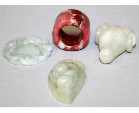 AN UNUSUAL CHINESE CELADON JADE MODEL OF A RAM'S HEAD, 1.8in long x 1.6in wide; together with two other celadon jade-like pen