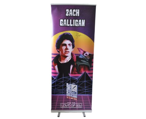Zach Galligan - Gremlins - autographed Monopoly Events banner from ' For The Love Of 80's' event. The banner depicting Gallig