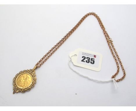 An Edward VII Sovereign, (loose?) set within 9ct gold openwork pendant mount, on a belcher link chain.   