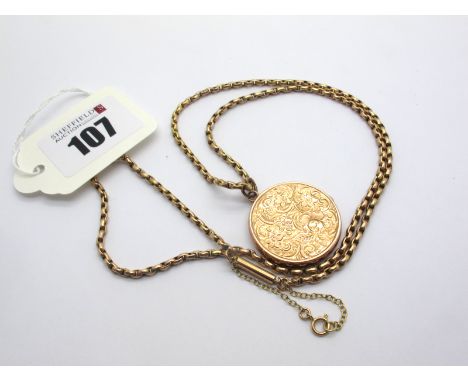 An Edwardian Circular Locket Pendant, allover foliate engraved, stamped "Back Front 9ct", on a chain stamped "9c". 