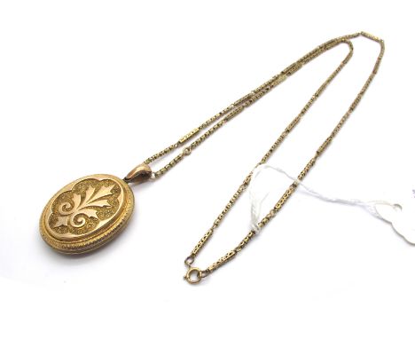 A Decorative Victorian Oval Locket Pendant, allover decorated, suspended on a long fancy link chain. 