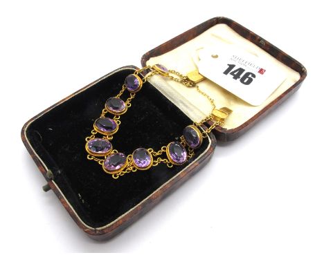 An Edwardian Amethyst Set Bracelet, composed of nine oval faceted amethysts, collet set on chain connections, to snap clasp s