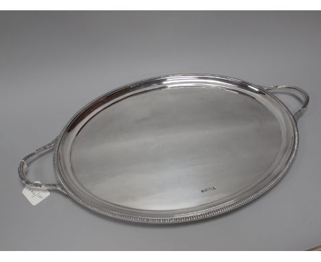 A Hallmarked Silver Twin Handled Oval Tray, Sterling Silverware Ltd, Sheffield 1975, of plain oval design, within textured bo