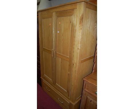 A contemporary light oak double door wardrobe, with single long lower drawer, w.111cm