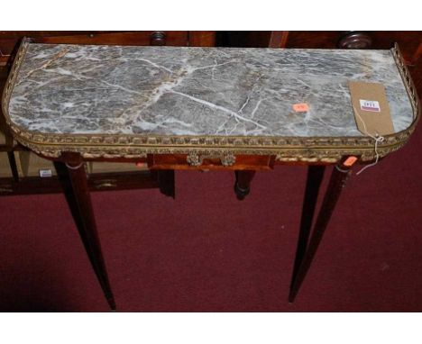 A French mahogany, gilt metal mounted and marble topped single drawer round cornered console table, raised on turned forelegs