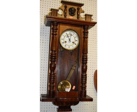 An early 20th century figured walnut Vienna drop trunk wall clock
