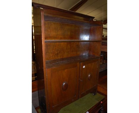 An Edwardian walnut bookcase cupboard, the open upper shelves over twin cupboard door base, width 86.5cm