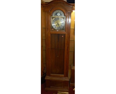 A contemporary oak long case clock, having glazed trunk door with silvered and brass arched moonphase dial, with three train 