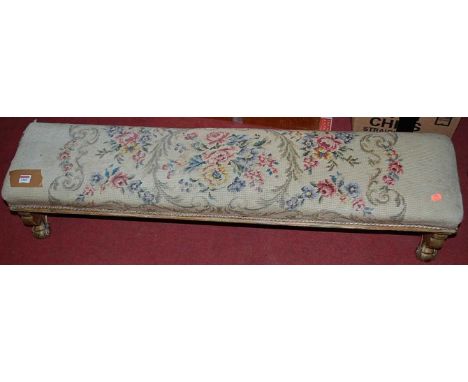 A 19th century floral gilt decorated and tapestry upholstered long foot stool, length 115cm