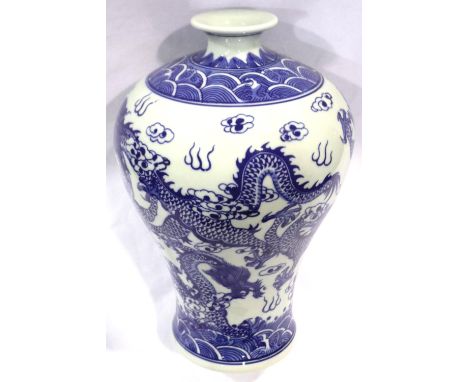 A large baluster form porcelain vase in the Qianlong style, decorated with five toed dragons amongst clouds to the body, flar