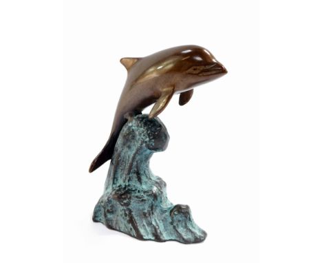 A bronze figure of a dolphin riding the wave, 15cm high.