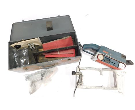 A Bosch electrical belt sander, GBS 75AE, boxed, with accessories.