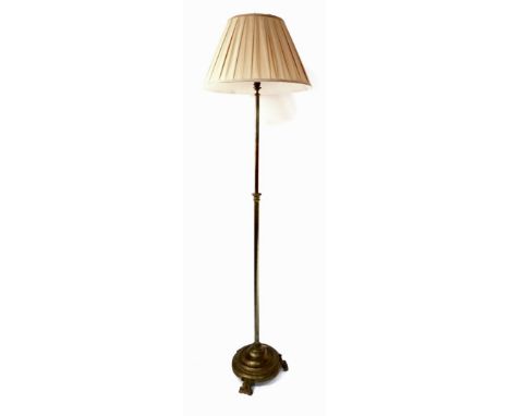 A Victorian brass telescopic standard lamp, with a silk shade, 185cm high extended.