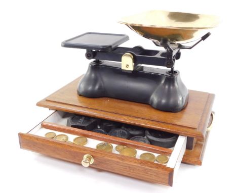 A set of brass and cast iron kitchen scales, raised on a twin handled mahogany base, with drawer opening to reveal cast iron 
