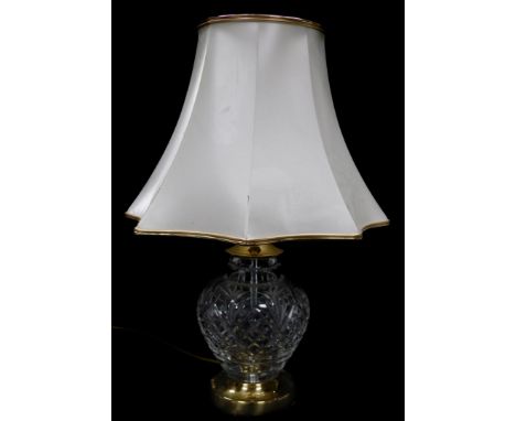 A Hampton cut glass table lamp, raised on a brass circular base, with a frilled octagonal shade, 48cm high.