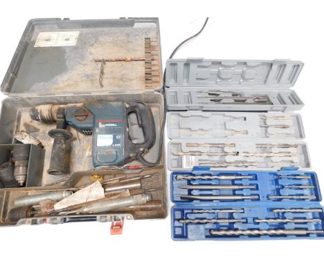 A Bosch hammer multi drill, model GBH4DFE, cased, with attachments, drill bits and chucks.