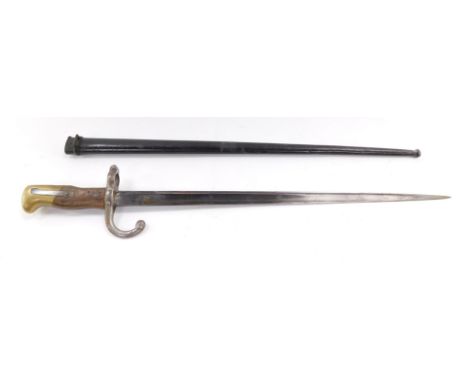 A St Etienne bayonet, with engraved blade dated 1877, with scabbard, 65.5cm wide.